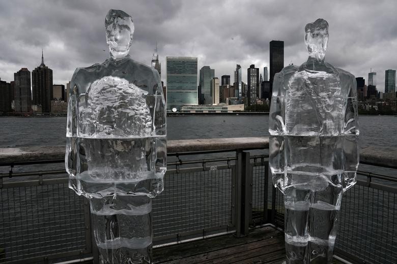 Two ice sculptures depicting U.S. President Donald Trump and Brazil's President Jair Bolsonaro sit across the Hudson River from the United Nations headquarters in Queens, New York.  REUTERS/Carlo Allegri    